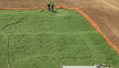 Professional hydroseeding on Milwaukee hillside for erosion control and slope stabilization